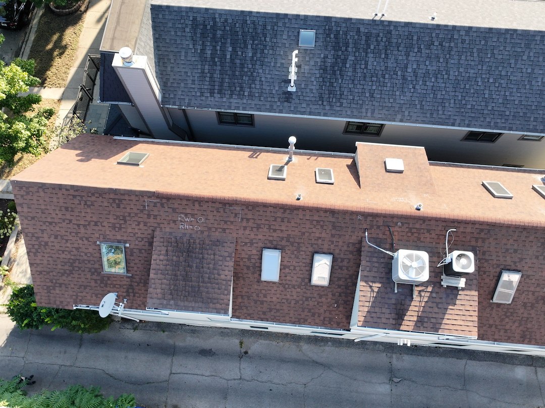 Why Does My Low-Slope Roof Look Fine but Still Leak Every Time It Storms?